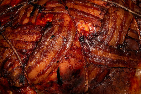 Close up of bacon covered roast chicken cooked in the oven and meat ready to be eaten
