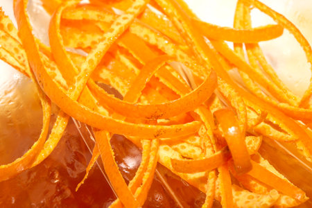 Close up of orange peel slices thin grated fruitの写真素材