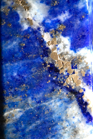 Close up of lapis lazuli blue and gold crystal gemstone harmony background