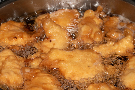 A Deep fried and golden battered chicken meat pieces golden fresly cooked