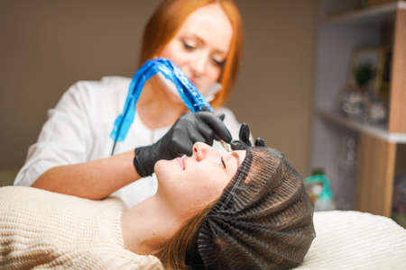 Girl master beautician makes permanent