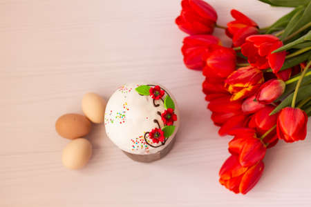 Easter cake and Easter eggs, Easter Orthodox sweet bread, Easter cake and colorful eggs with tulips, Holidays breakfast concept with copy space.の写真素材