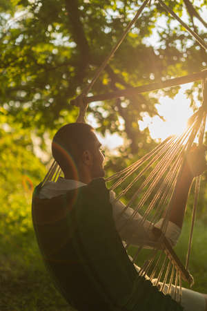 relaxing in a hammock on a sunny dayの写真素材