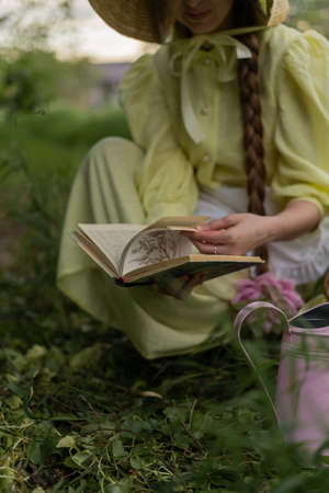 Girl transplants in home garden