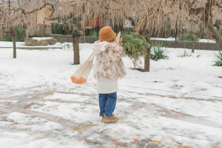 girl with a bouquet of Christmas treesの写真素材