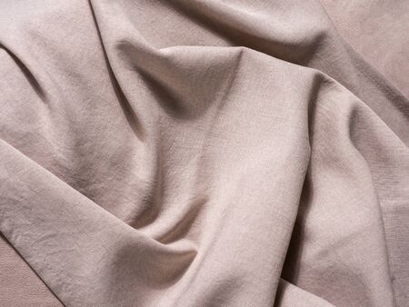 beige fabric. cotton. wavy folds. textile
