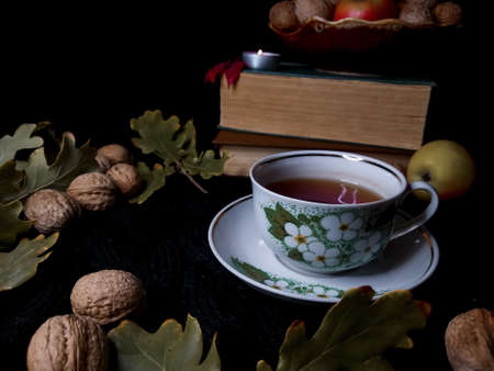 Cup of black tea with nutsの写真素材