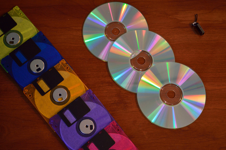 Floppy disks, cd roms, and a flash drive, showing progression of technology.の写真素材