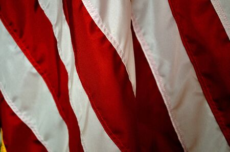 Red stripe patriotic holiday background of the american flag, closeup. Emblem of freedom and democracy. red stripes  of the flag of the United States of America.の写真素材