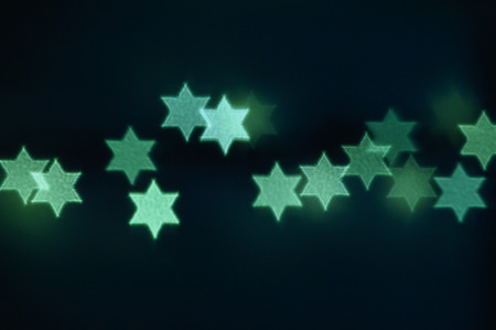 Beautiful bokeh lights in shape of the Star of David for Hanukkah celebration. Jewish Holiday background.の写真素材