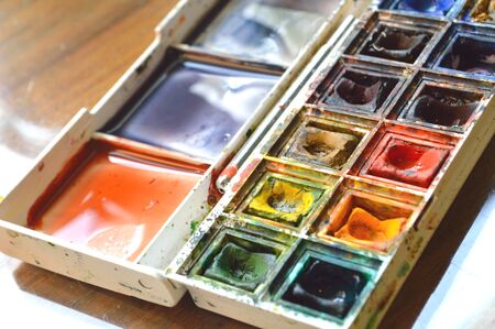 Closeup of compact, travel size, watercolor palette. Real artist's stuido supplies, well used. の写真素材