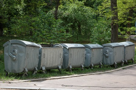 Row of large green wheelie bins for rubbish, recycling and gardeの写真素材