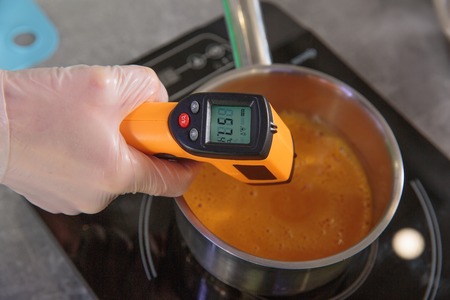 measuring the temperature of cream soup by digital thermometerの写真素材