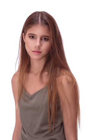 Portret of young woman with brown hair on white backgroundの写真素材