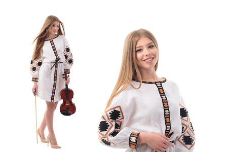 Double portrait of Beautiful Ukrainian woman in national costume. Attractive Ukrainian woman wearing in traditional Ukrainian embroidery, standing over isolated white background.の写真素材