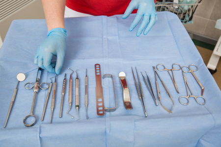 Detail of hand holding dental tools in dental clinic. Dentist concept. Dental officeの写真素材