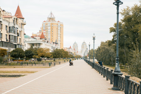 Cityscape. Urban road in a typical street of modern buildings in big city. Bird and green trees in residential district.のeditorial素材