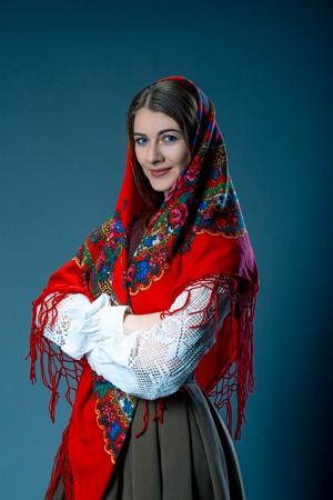 Russian beauty woman in the national patterned shawl on blue grey background. Maslenitsa. Model testの写真素材
