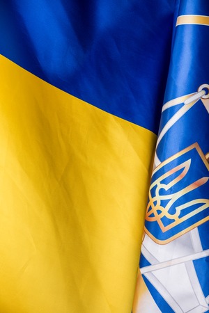 Realistic flag and emblem of Ukraine on the wavy surface of fabricの写真素材