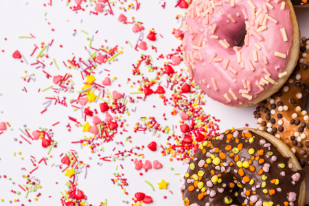 homemade colorful donuts with chocolate and icing glaze on white background. Copy spaceの写真素材