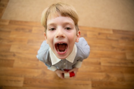 Little boy screaming. boy with open mouth. view from aboveの写真素材