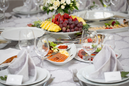 Buffet table of reception with cold snacks, meat, salads and fruits. fish and red caviarの写真素材