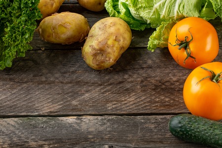 Composition with assorted raw organic vegetables on broun wooden backgroundの写真素材
