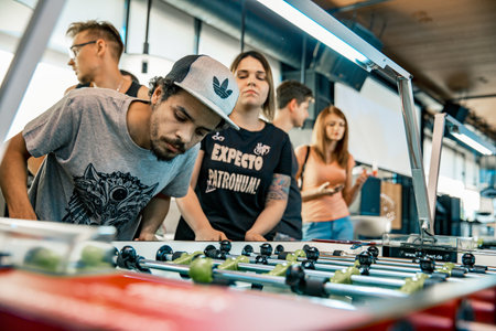 Photo KYIV, UKRAINE, bar league of Grants KickerKicker 10 June 2018. Active men and women have fun during table soccer game. Competitions and qualifying roundのeditorial素材