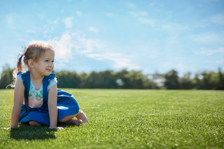 happy girl portrait on the grass on a sunny day. happy childhood. Copy spaceの写真素材