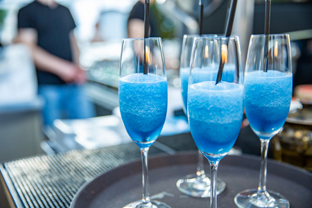 Martini. Alcohol drinks and cocktails on bar. colored light. blue cocktails in a restaurant on a trayの写真素材