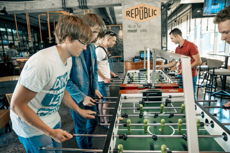 KYIV, UKRAINE, bar league of Grants KickerKicker 10 June 2018. Active men and women have fun during table soccer game. championshipのeditorial素材