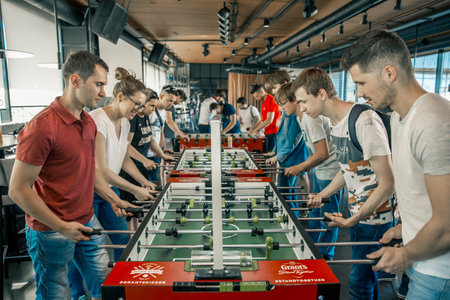 KYIV, UKRAINE, bar league of Grants KickerKicker 10 June 2018. Active men and women have fun during table soccer game. championshipのeditorial素材