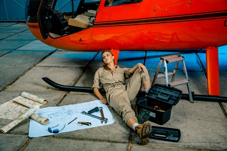 female helicopter technician tired at work. gender equality. feminismの写真素材