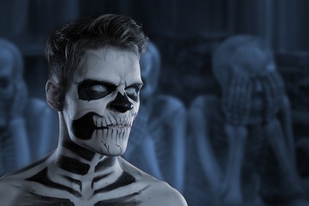 Dia de los Muerto Costume - Day of the dead is a mexican holiday. Here is a man with skull face and blurry backgroundの写真素材