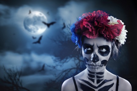 Woman art make up. Scary skull make-up for Halloween. Face-art body-art is painted, paints for body art cosmetics skin. Horror beauty nightmares.の写真素材