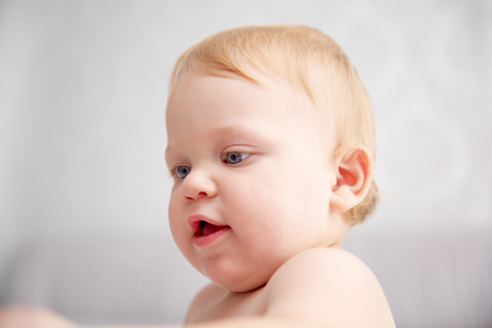 Close up portrait of cute little boy one year old on backgroundの写真素材