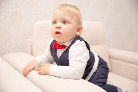 Happy baby. Little boy one year old in a white shirt and bow tie. Children portrait. Stylish man in fashionable a bow-tie.の写真素材