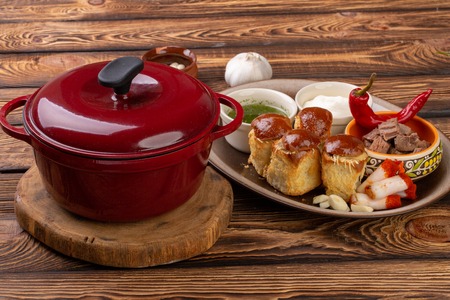 Traditional Ukrainian borscht. Borscht pan. Borsch fresh Ukrainian red. Full pan of delicious red borsch. Traditional Ukrainian cuisine with fat, meat, pampushka, sour cream, garlic Sauseの写真素材