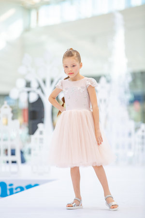 Kyiv, Ukraine March 03.2019. UKFW. Ukrainian Kids Fashion Day. Little girl wearing at pastel dress posing at podiumのeditorial素材