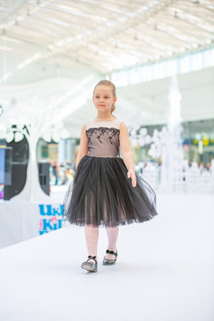 Kyiv, Ukraine March 03.2019. UKFW. Ukrainian Kids Fashion Day. Little girl model weared at black dress posing at the podium at the fashion showのeditorial素材