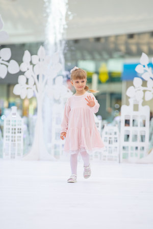 Kyiv, Ukraine March 03.2019. UKFW. Ukrainian Kids Fashion Day. Little girl model weared at pastel dress posing at the podium at the fashion showのeditorial素材