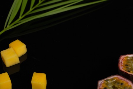 A peeled diced pineapple, bamboo and passion fruit.の写真素材