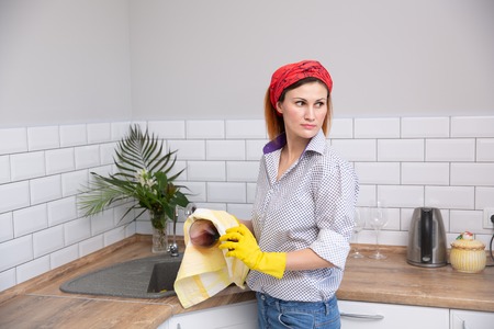 Woman cleaning or ruges glass in the kitchen. housekeeper doing spring cleaningの写真素材
