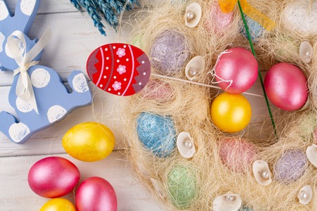 Easter decoration with toy rabbits, eggs on light wooden backgroundの写真素材