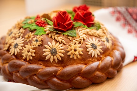 Bread lies on embroidery. Loaf wedding cake with flowersの写真素材