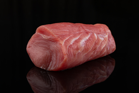 A piece of Fresh and raw tuna meat on a blackの写真素材
