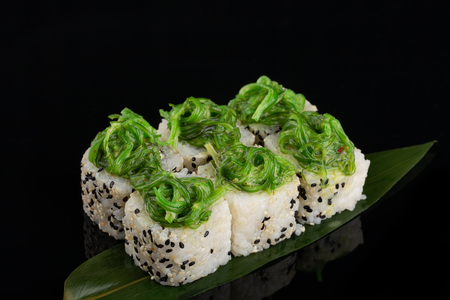 The Vegetable maki sushi rolls with seaweed on banana leaf at blackの写真素材