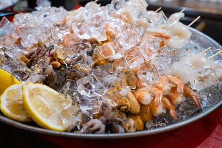 An extraordinary plate French oysters, shrimps, kebabs from Mixed Cold Seafood with lemon, and Ice