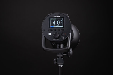 Photo studio strobe light flash bulb monoblock. Close up view of professional studio strobe flash lamp on black background. Jinbei. view of the display with different settingsのeditorial素材