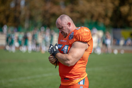 American football player wearing glove on stadium background. american football competitions Stallions Kyiv - Hurricanes Minsk 08.09.2019のeditorial素材